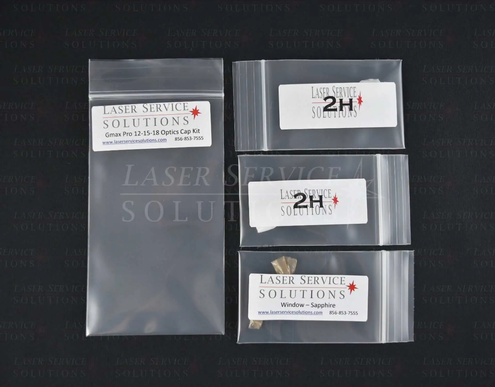 Four clear plastic bags, each labeled “Laser Service Solutions,” contain Candela Gmax Pro Optics Cap Lens Kit components and caps for laser equipment, with contact information printed on the labels.