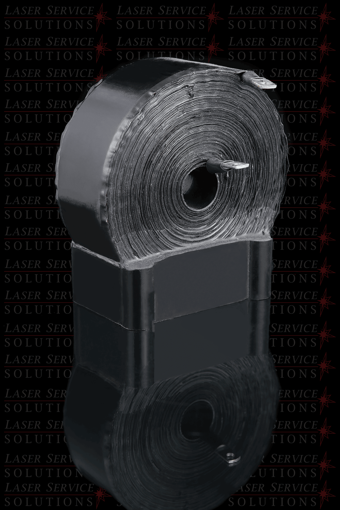 A large Candela MGL 750uF Inductor Coil stands upright on a reflective surface, with a metallic fastener inserted in the center. The background features repeated red text reading LASER SERVICES SOLUTIONS.