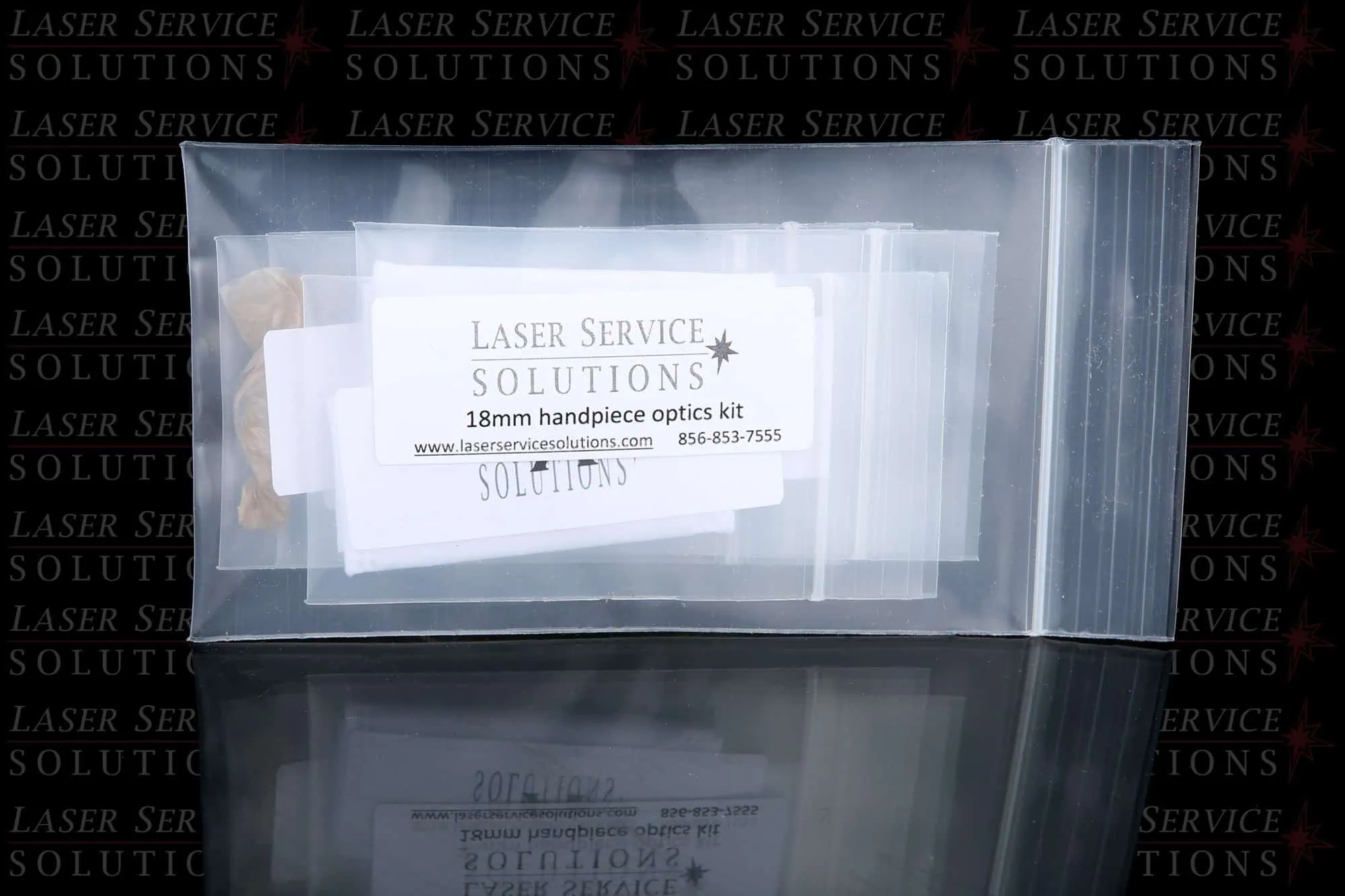 A clear plastic bag labeled Elite+ Handpiece Optics Kits, containing small packets inside and displayed against a branded background.