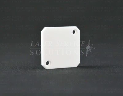 Candela GMax Pro Ceramic Reflector for Shutter Assembly — a white, rectangular ceramic component with two holes at adjacent corners, featuring slightly beveled edges and shown upright on a dark textured surface.