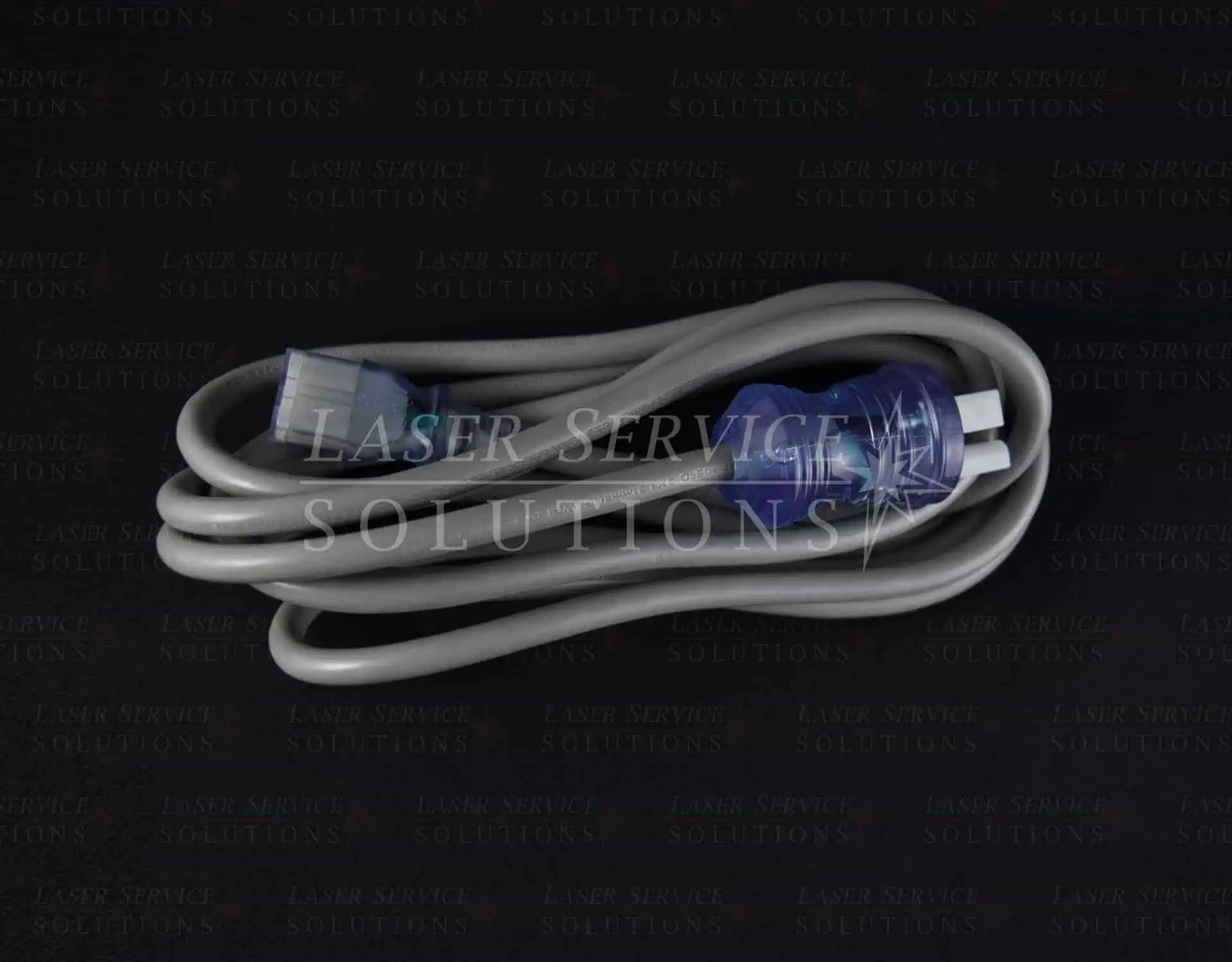 A Soprano XL Power Cord, featuring a coiled gray design with blue connectors on both ends, is displayed against a black background with the Laser Service Solutions logo faintly visible in the backdrop.