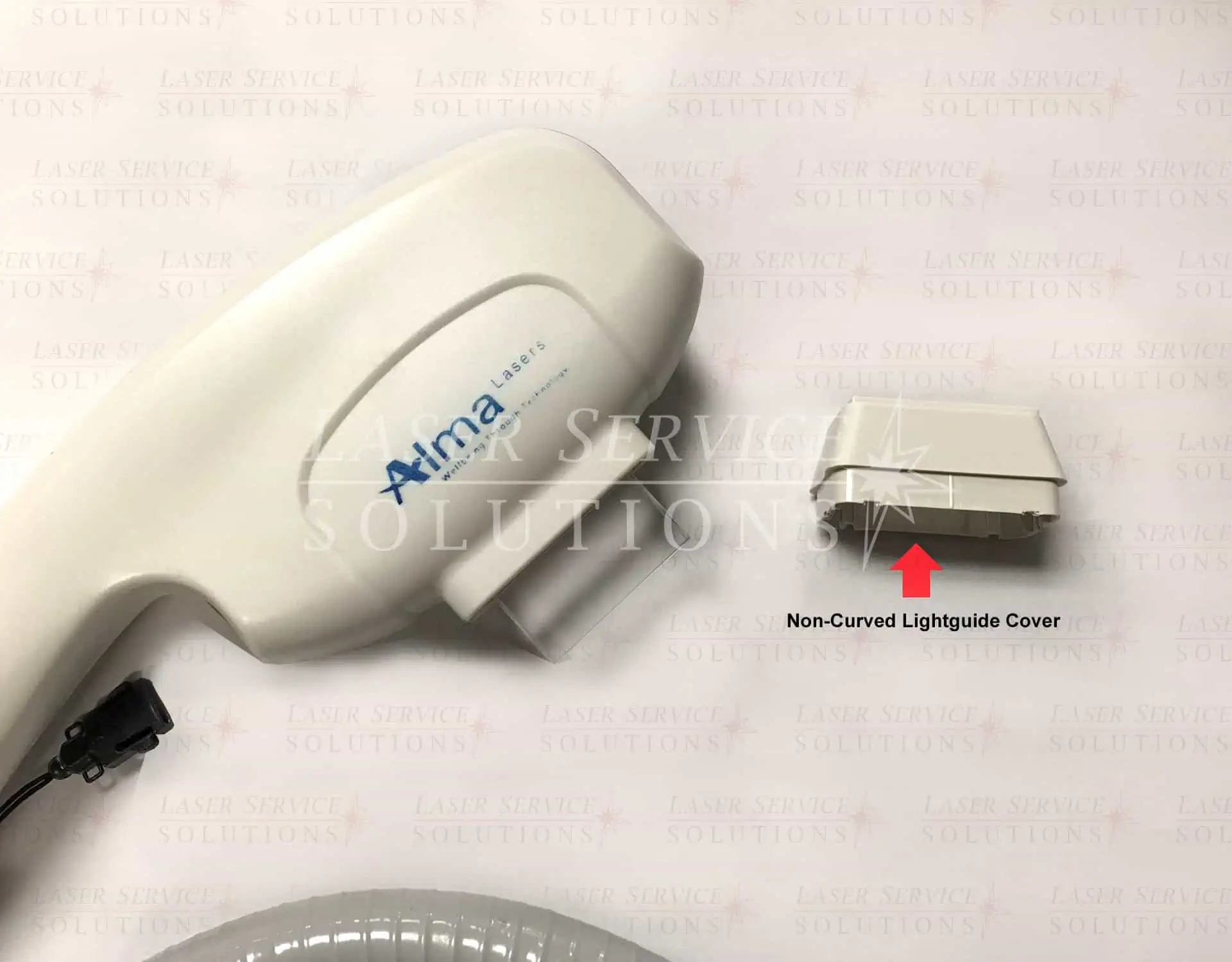 Close-up of an Alma laser handpiece and a detached Harmony Lightguide Cover, with a red arrow pointing to the cover. Background features a faint repeating Laser Service Solutions logo.