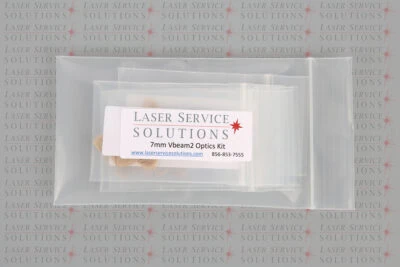A plastic bag labeled Laser Service Solutions Candela Vbeam Perfecta Optics Kits with contact info, placed on a background printed repeatedly with Laser Service Solutions.