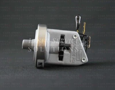 A close-up side view of a Candela Vbeam Perfecta Dye Pressure Switch with a metallic finish and electrical connector, set against a dark background with faint text reading Laser Service Solutions.