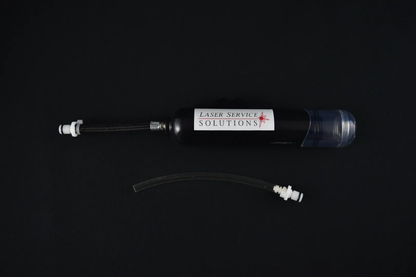 A Soprano Handpiece Drain Kit, a black cylindrical device labeled Laser Service Solutions with attached tubing and a separate tube, displayed on a black background.