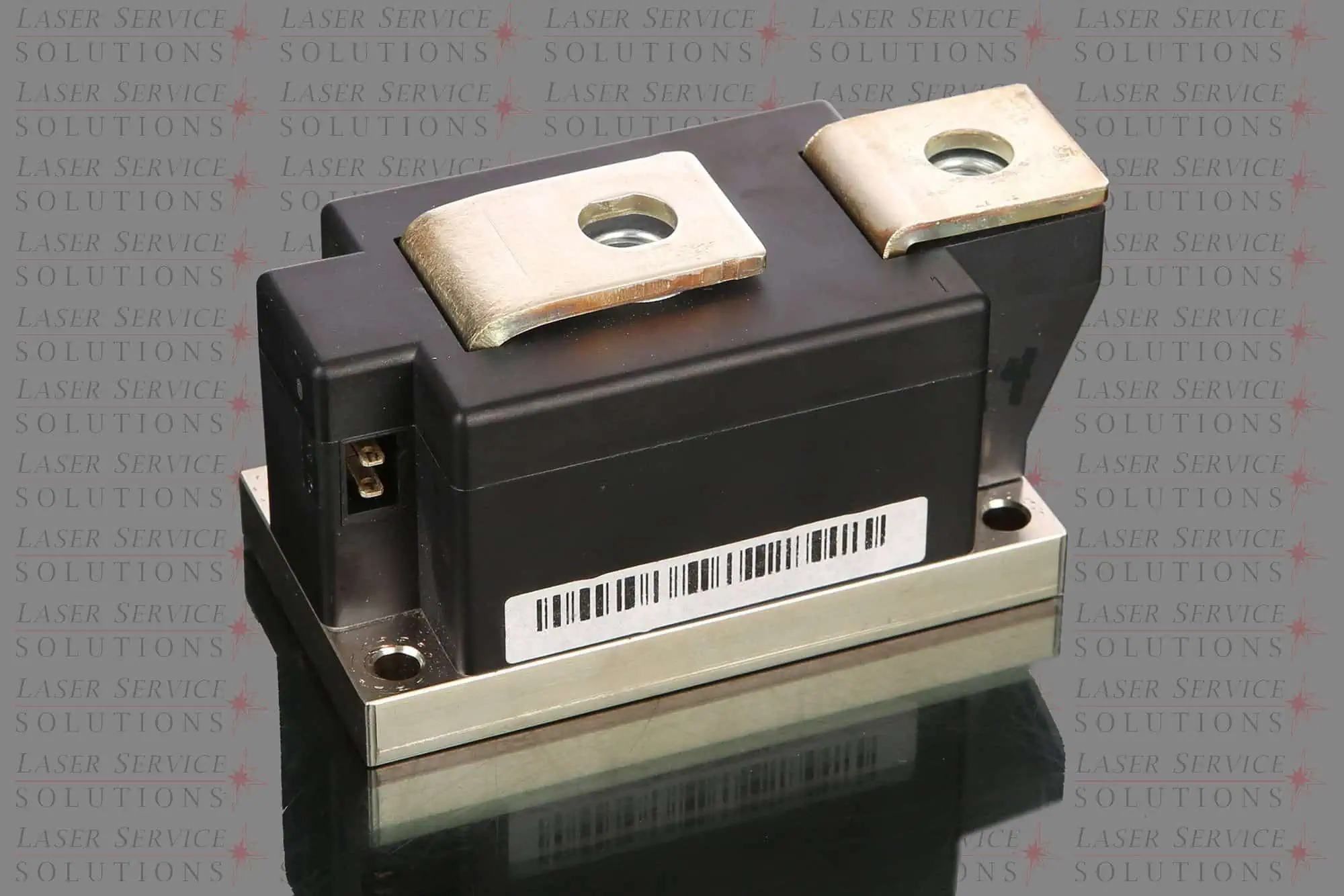 A close-up of a Candela Vbeam Perfecta HV Diode power module in black, featuring metal terminals and a barcode label, is positioned on a reflective surface. The background is repeatedly watermarked with Laser Service Solutions.
