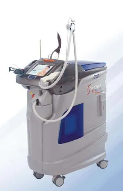 The DEKA Synchro Replay is a medical laser machine featuring a digital display, control buttons, and attached handpieces, all mounted on wheels for mobility, designed for dermatological and cosmetic procedures.
