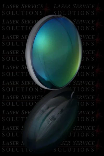 An Elite MPX Fiber Focusing Lens in green and blue stands upright with its reflection visible below, set against a black background patterned with the words “Laser Service Solutions.”.