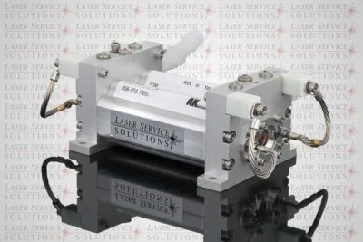 An Elite MPX Pump Chamber from Laser Service Solutions is displayed on a reflective surface with hoses and fittings attached, set against a background featuring a repeating Laser Service Solutions logo.