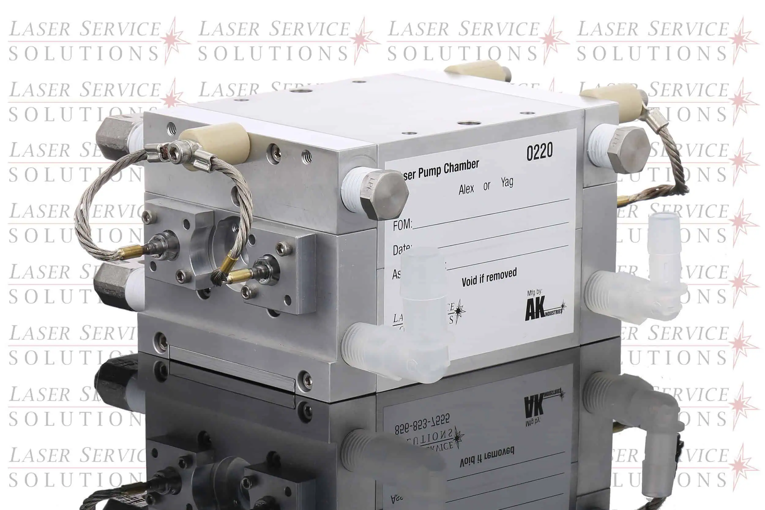 Elite+ Yag Pump Chamber—rectangular metal laser pump chamber with attached hoses and connectors, labeled with product information, displayed on a reflective surface featuring a Laser Service Solutions watermark in the background.