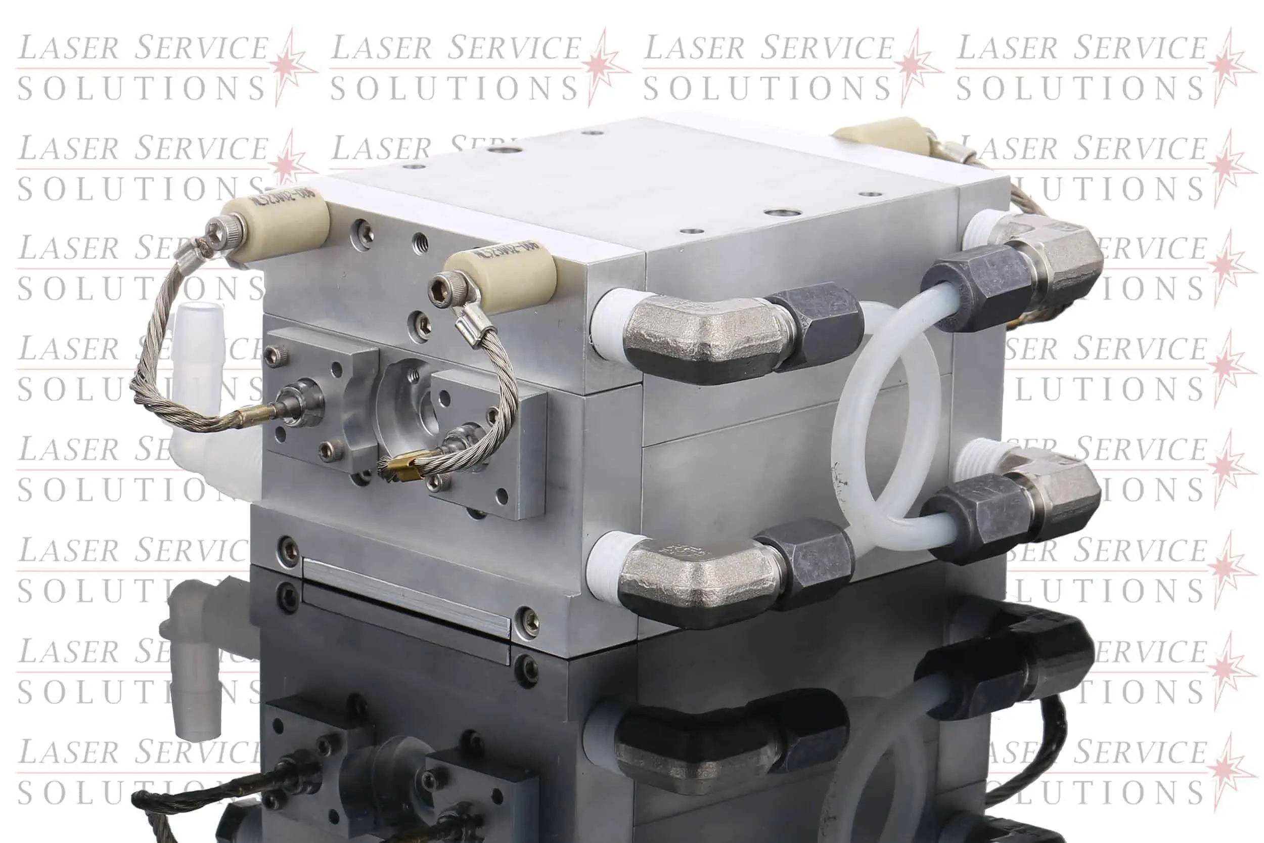 Elite+ Yag Pump Chamber—rectangular metal laser component featuring multiple attached pipes and cables, placed on a reflective surface. The background displays a repeated Laser Service Solutions logo in light gray and red.