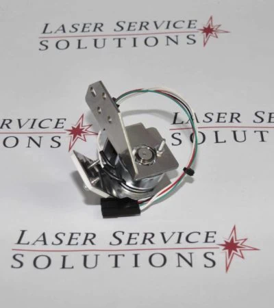 The Gmax Pro Shutter Assembly (Beam Block Assembly), featuring attached wiring, rests on a surface printed with Laser Service Solutions and red star logos, displayed from an angled top-down perspective.