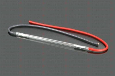 A Harmony QSYag Flashlamp with attached red and black cables, set against a gray background featuring a faint Laser Service Solutions text pattern.