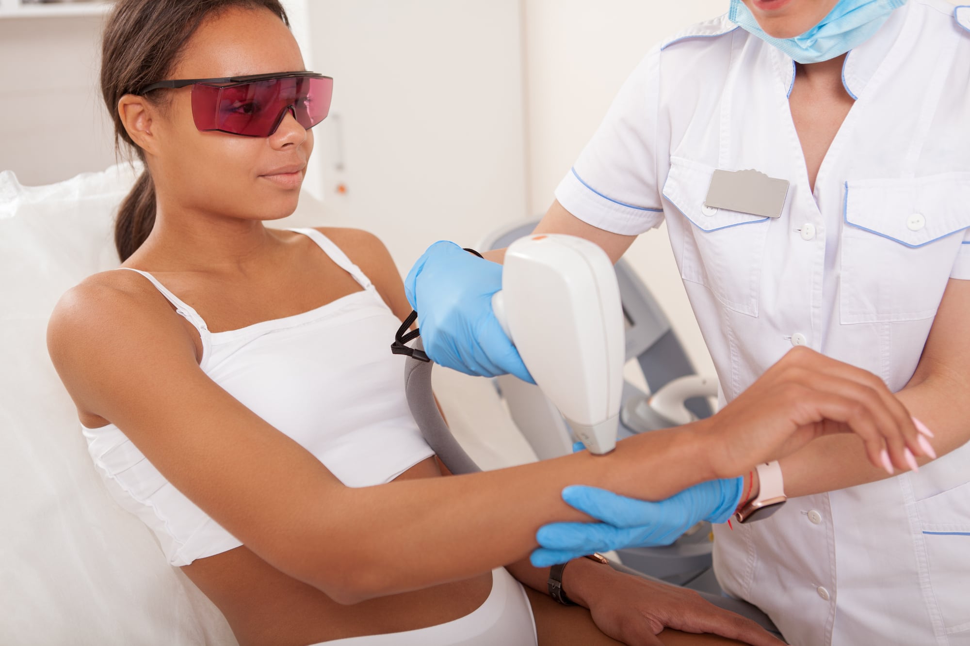 Woman with dark skin getting laser hair removal treatment