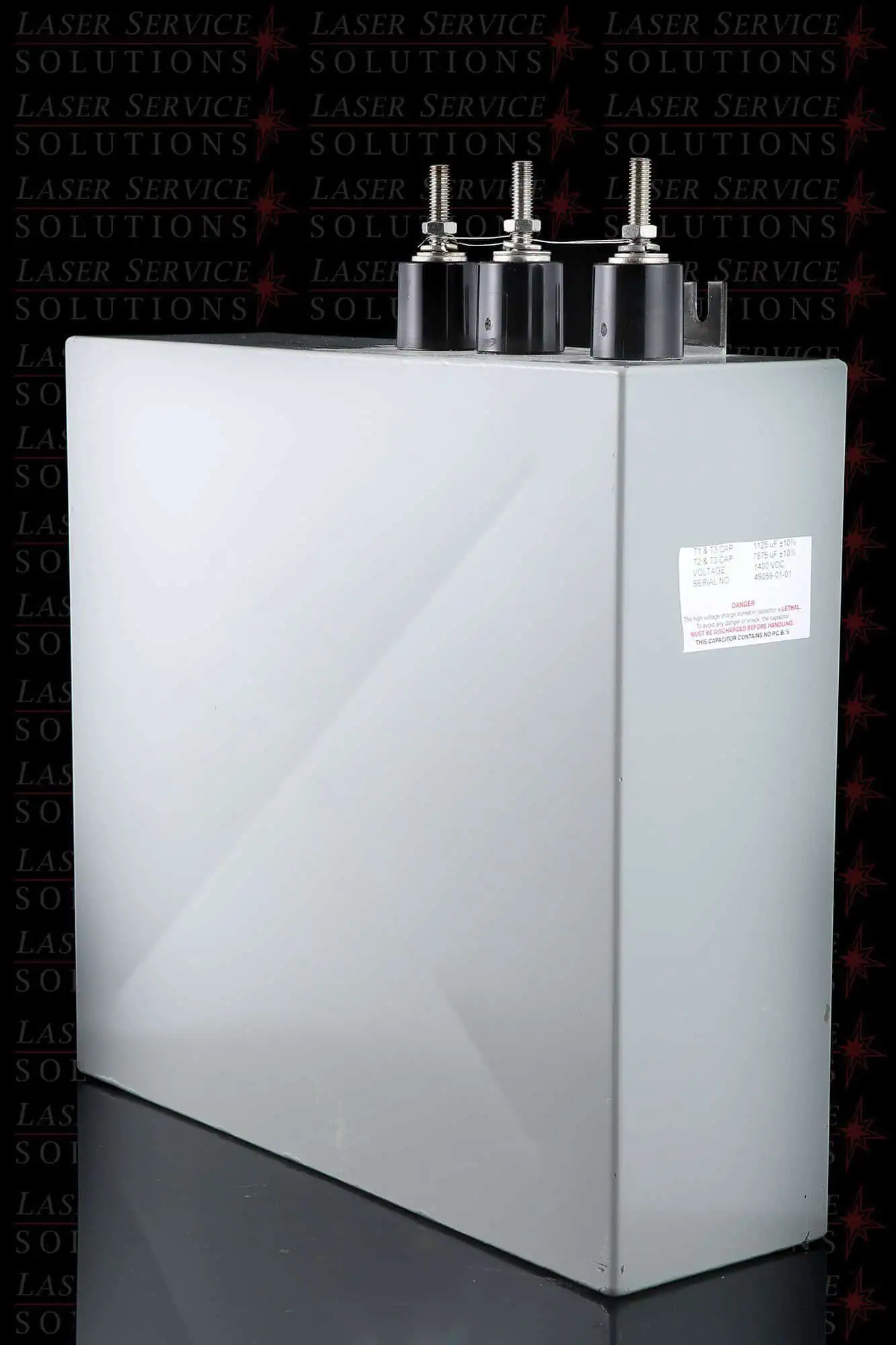 A Candela MGL Capacitor Bank, featuring a large rectangular gray industrial design with three terminal posts on top and a side label, is placed against a black background patterned with repeated Laser Service Solutions text.
