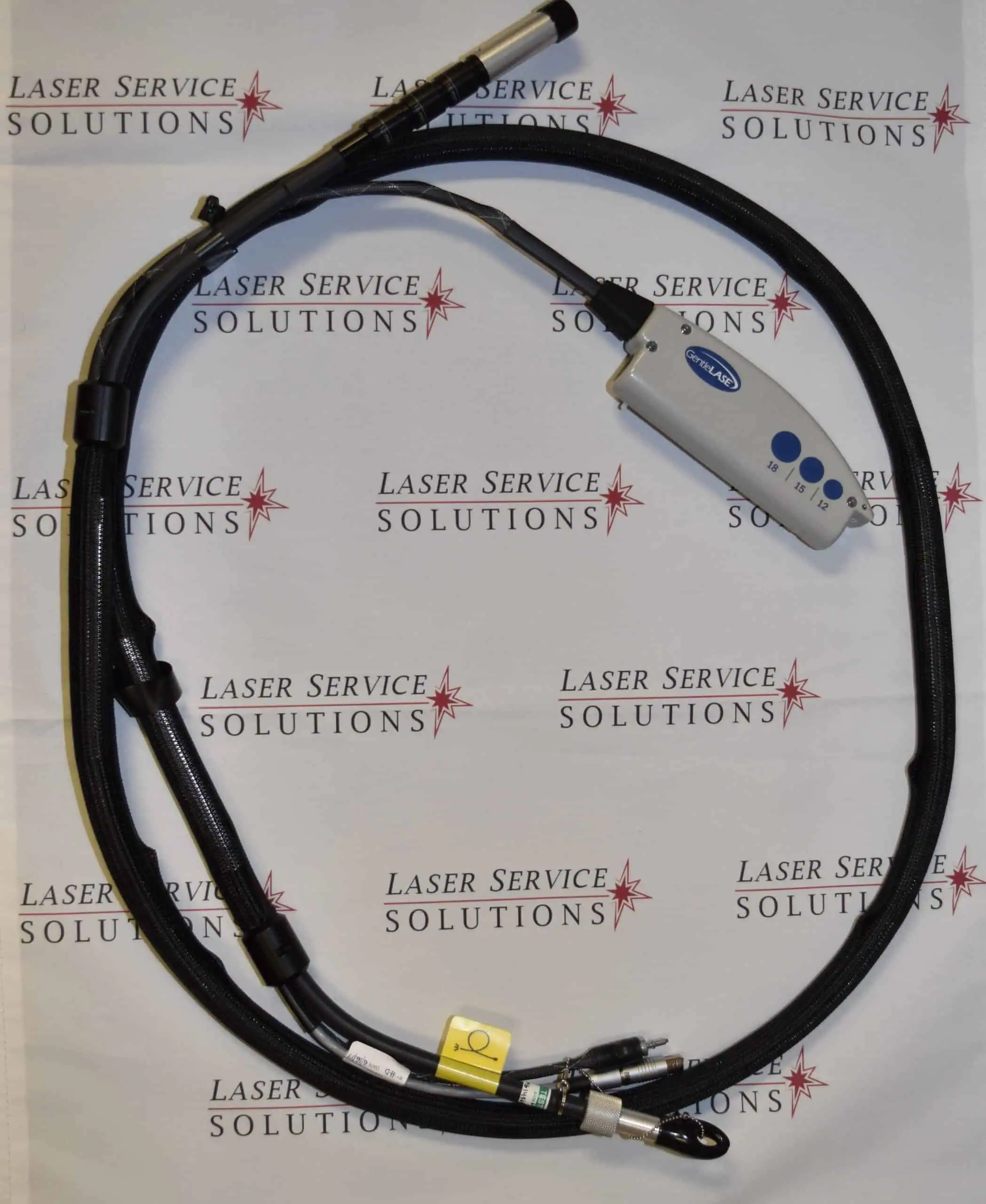 A Candela MGL Delivery System - Complete, featuring a black laser fiber cable with a control handle and connectors, is coiled on a Laser Service Solutions branded background.