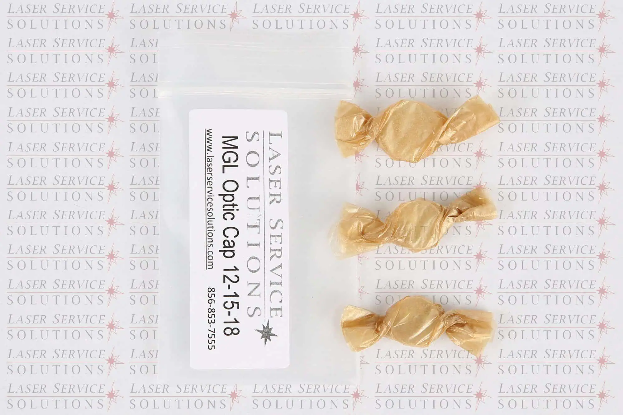A labeled plastic bag reading “Candela MGL Optics Cap Lens Kit - 12/15/18mm” is placed next to three gold-wrapped candies, on a background with repeating Laser Service Solutions text.