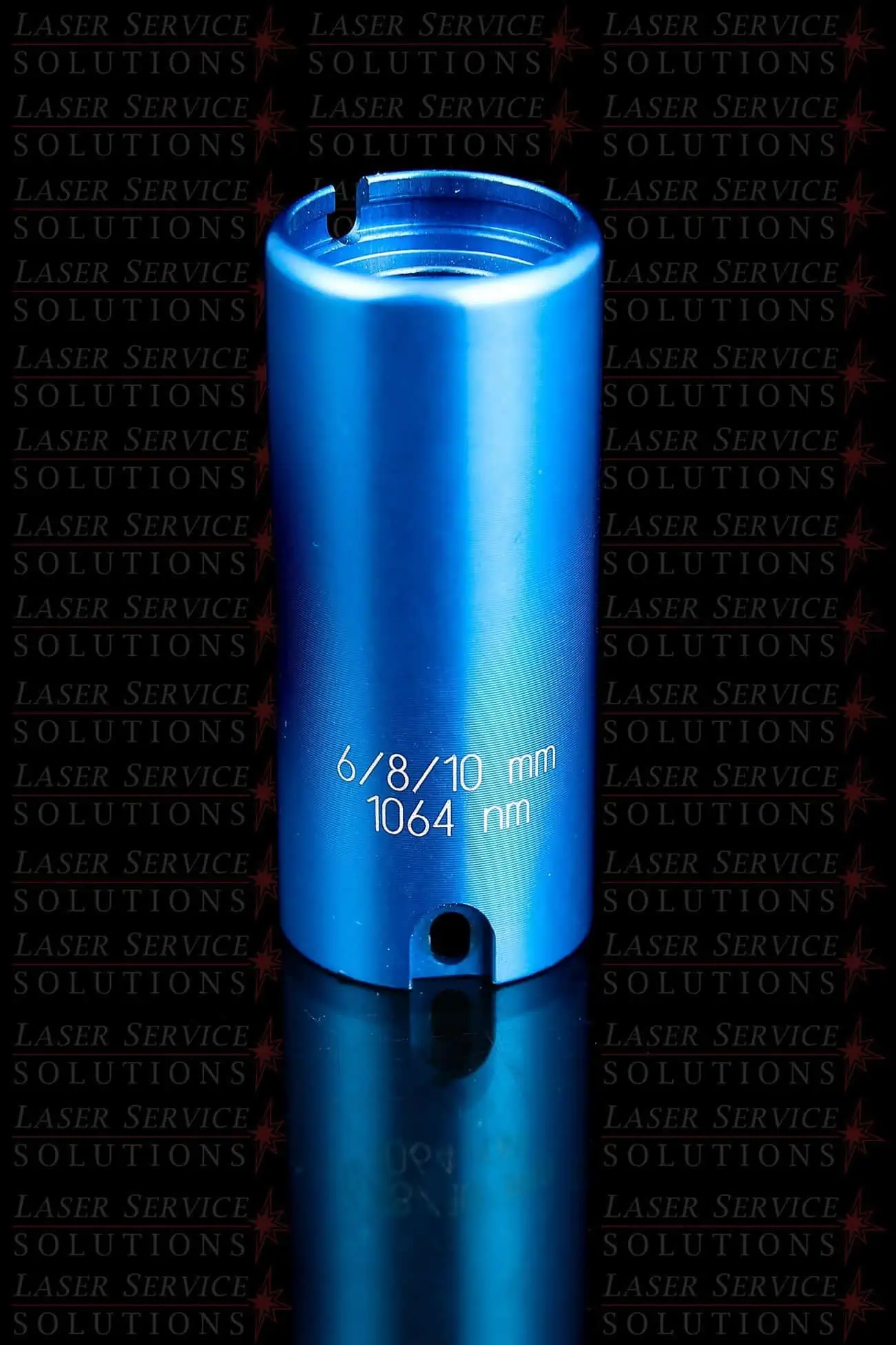 A blue metallic cylindrical Candela MGL Optics Cap Lens Kit - 6/8/10mm, engraved with “1064 nm” on its side, stands upright on a glossy black surface against a repeating LASER SERVICE SOLUTIONS background.
