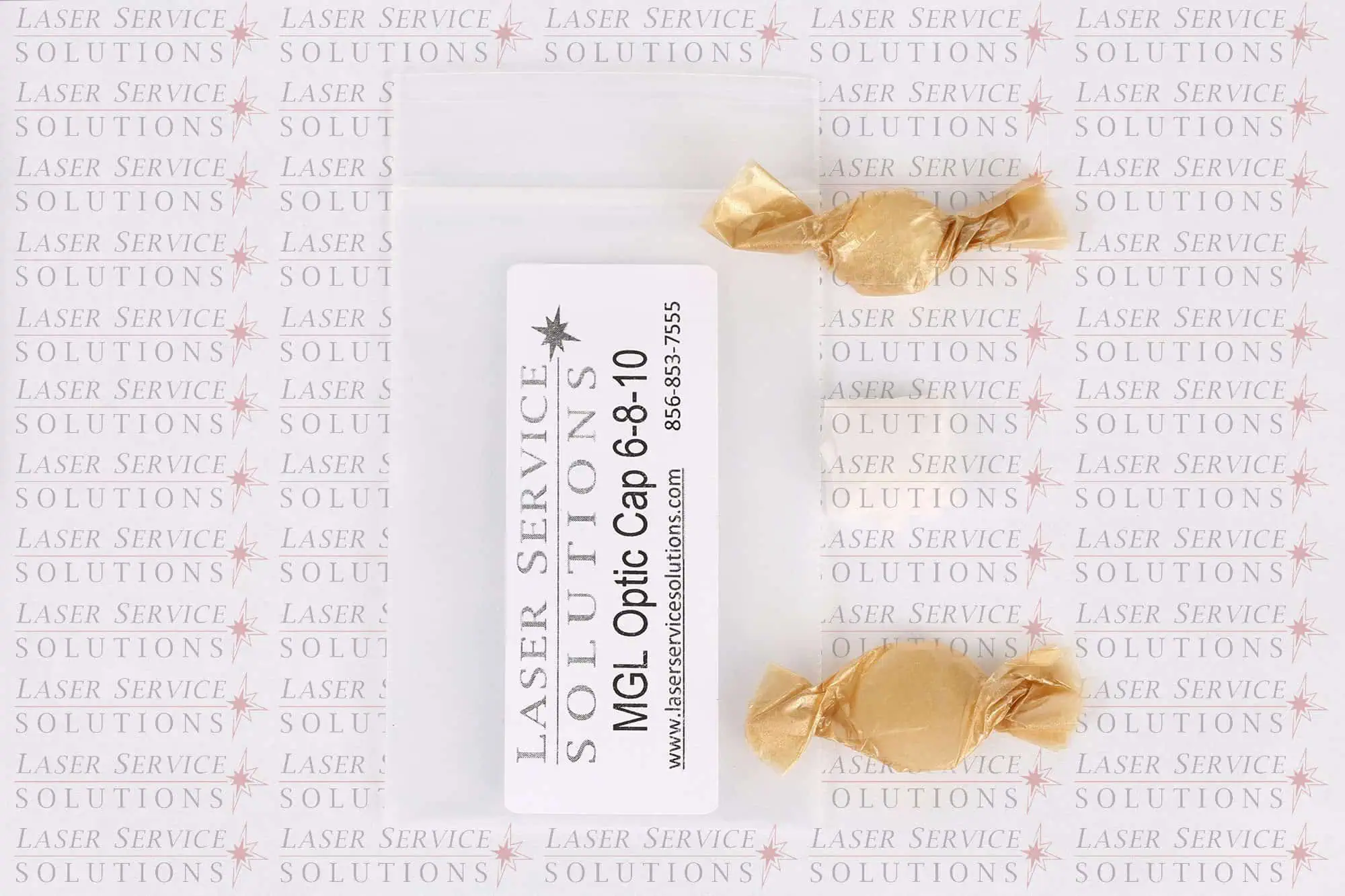 A small plastic bag labeled “Candela MGL Optics Cap Lens Kit - 6/8/10mm” with two wrapped candies beside it, on a background repeating Laser Service Solutions.