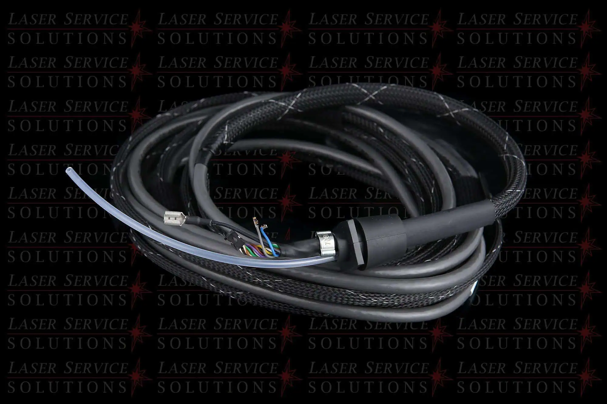 A coiled bundle of Candela MGY Communication Cable, black in color with exposed colored wires at one end, set against a background featuring the repeated text Laser Service Solutions.