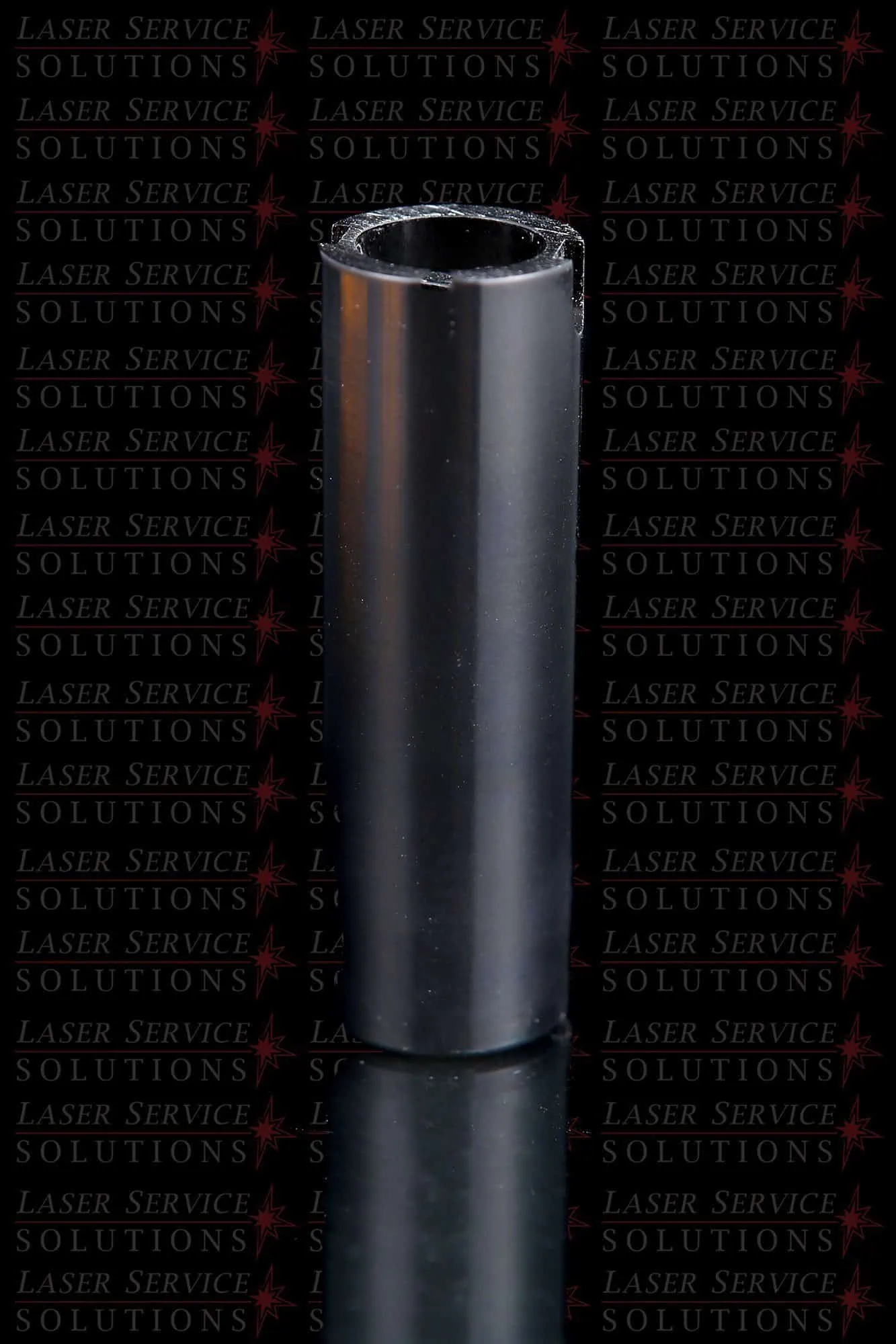 A shiny black cylindrical tube, the Candela MGY Optics Cap Lens Kit - 12/15/18mm, stands upright on a reflective surface, with LASER SERVICES SOLUTIONS repeatedly printed in the background.