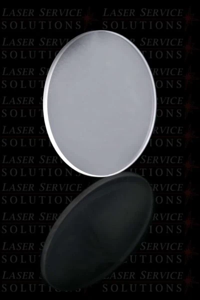 An Elite Resonator Sapphire Window, featuring a round, flat glass optic with a slim metallic edge, is displayed upright and casts a reflection below. The background displays a repeating Laser Service Solutions watermark.