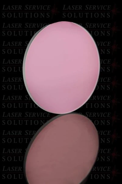 A round, pink Elite Resonator Shutter Mirror is displayed upright with its reflection visible below it. The background is black, featuring the words “LASER SERVICE SOLUTIONS” repeatedly printed in gray text.