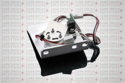 Elite Yag Intracavity Shutter electronic component features attached wires, a circuit board, and a mounting bracket, positioned on a reflective surface. In the background, repeating Laser Service Solutions text and red laser beam graphics are visible.