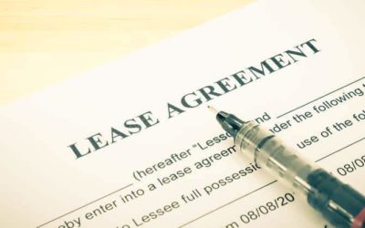 A lease agreement sits on a table with a pen.